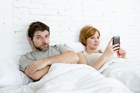 couple_in_bed_husband_frustrated_upset_and_unsatisfied_while_cg1p16423600c_th